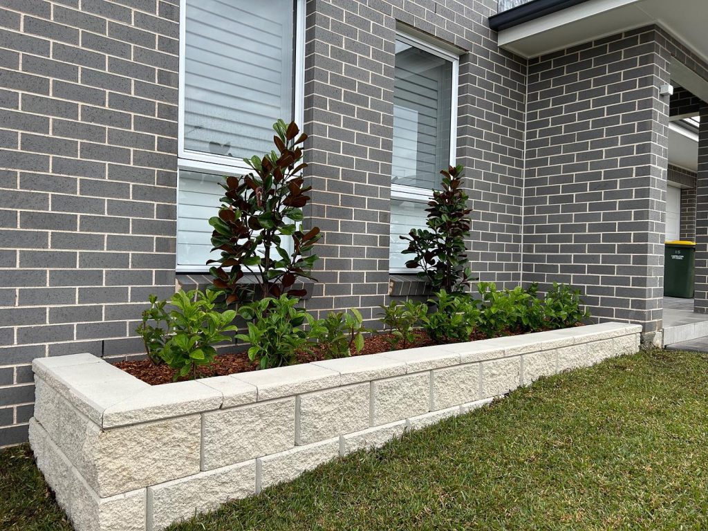 Strong and stylish stone retaining wall constructed by T&J Landscaping in the Hills District