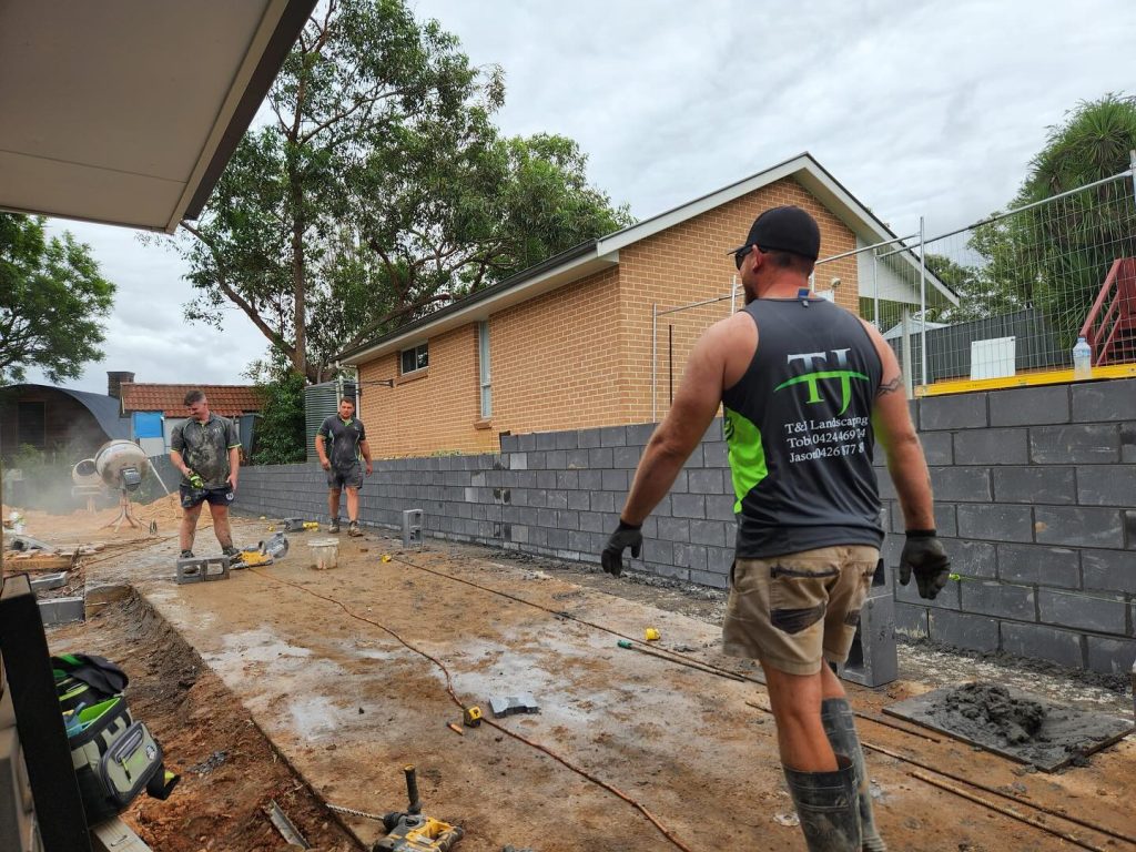 Custom-built stone retaining wall with garden beds by professional landscapers in Inner West